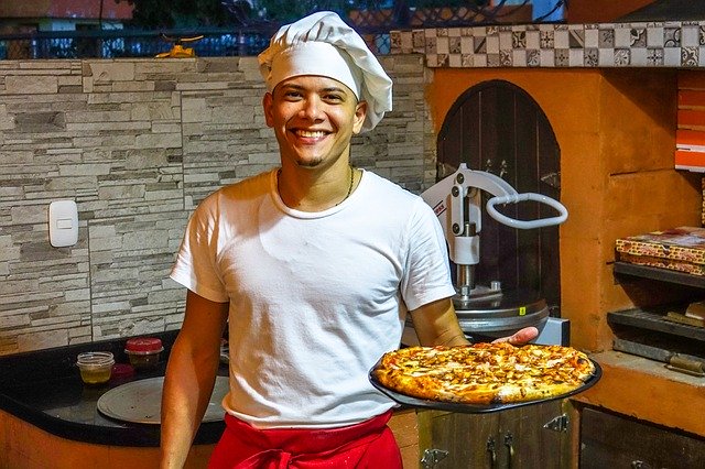 Takeaway Promotions: A Guide to Takeaway Success 5 Man Holding a Pizza