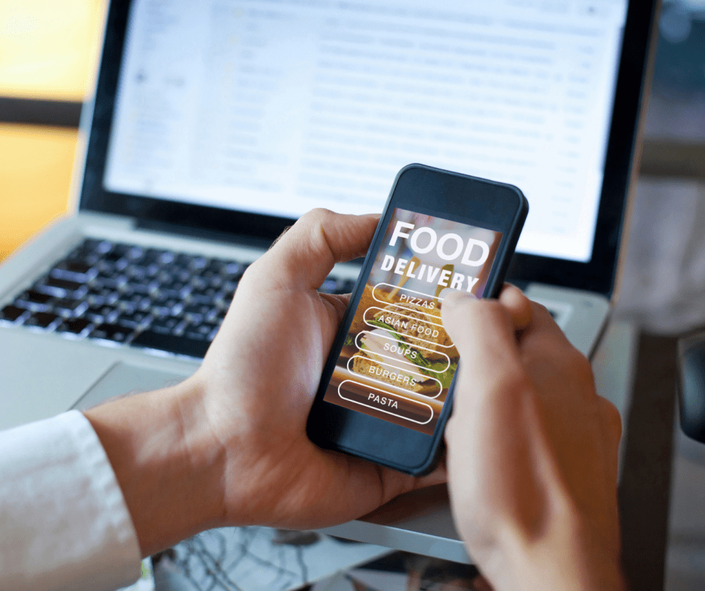 Mobile App For Restaurants - 10 Basic Features To Check Out 2 Ordering food using a Food Delivery app on a mobile phone.